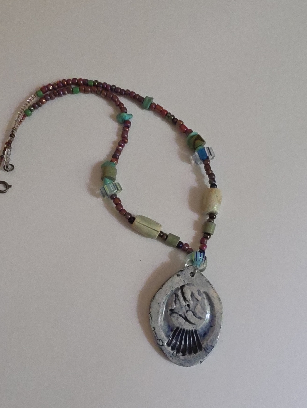Handmade Multicolor Beaded Necklace with Blue Stamped Pendant